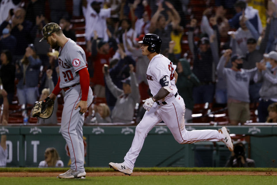 Boston Red Sox's Bobby Dalbec runs the bases past Los Angeles Angels first baseman Jared Walsh after his two-run home run during the seventh inning of a baseball game Friday, May 14, 2021, at Fenway Park in Boston. (AP Photo/Winslow Townson)