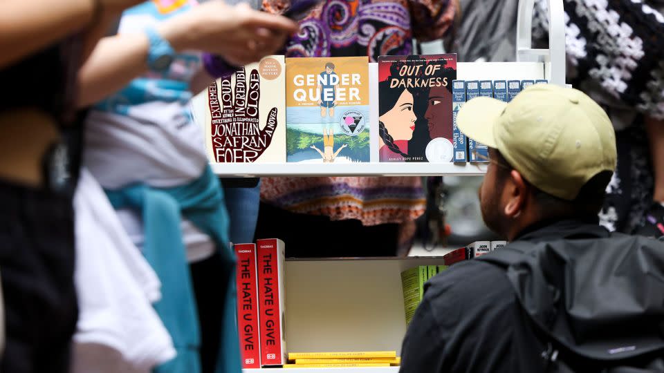 A person looks at the free banned books during the MoveOn "Banned Bookmobile" Tour stop outside of Sandmeyer's Bookstore in the South Loop on July 13, 2023. - Eileen T. Meslar/Chicago Tribune/Getty Images