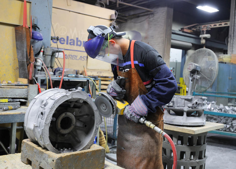 A worker cuts a cast at Mitchell Aerospace, Inc., a manufacturer of light alloy sand castings for the aerospace industry, in Montreal, Quebec, Canada September 9, 2022.  REUTERS/Christinne Muschi