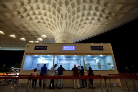 Passengers check the status of their flights at a Jet Airways ticketing counter at the Chhatrapati Shivaji Maharaj International Airport in Mumbai