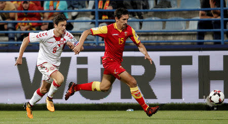 Soccer Football - 2018 World Cup Qualifications - Europe - Montenegro vs Denmark - Podgorica City Stadium, Podgorica, Montenegro - October 5, 2017 Denmark's Thomas Delaney in action with Montenegro's Stefan Savic REUTERS/Stevo Vasiljevic