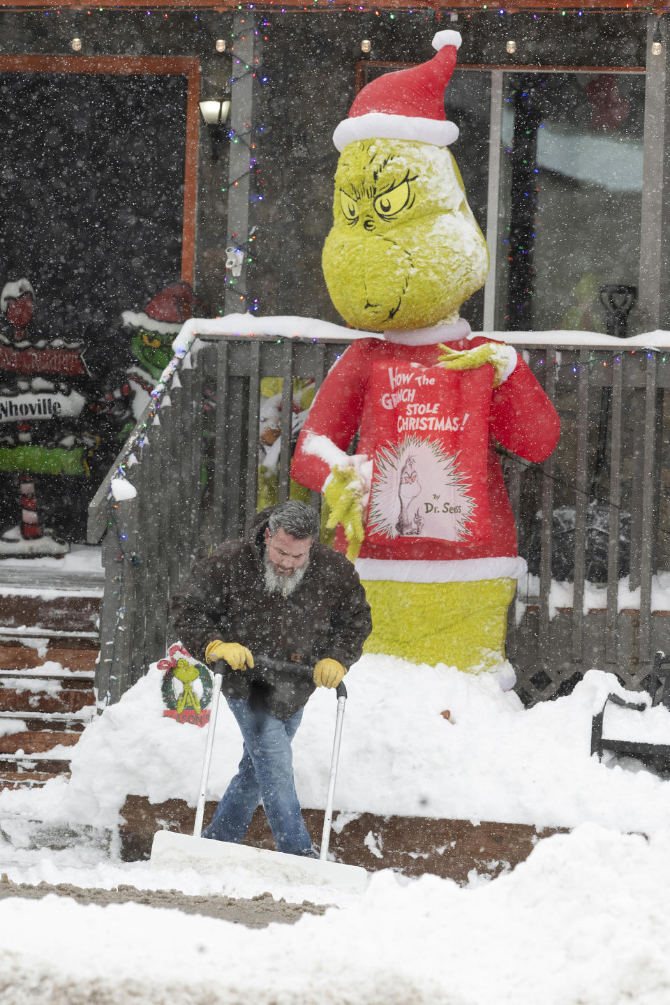 Drake Prokop shovels snow hit in front of Bino's Pizza after a blizzard on Tuesday, Dec. 26, 2023, in Kiowa, Colo. (Jerilee Bennett/The Gazette via AP)