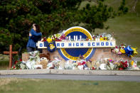 Gov. Gretchen Whitmer embraces Oakland County Executive Dave Coulter as the two leave flowers and pay their respects Thursday morning, Dec. 2, 2021 at Oxford High School in Oxford, Mich. A 15-year-old boy has been denied bail and moved to jail after being charged in the Michigan school shooting that killed four students and injured others.(Jake May/The Flint Journal via AP)