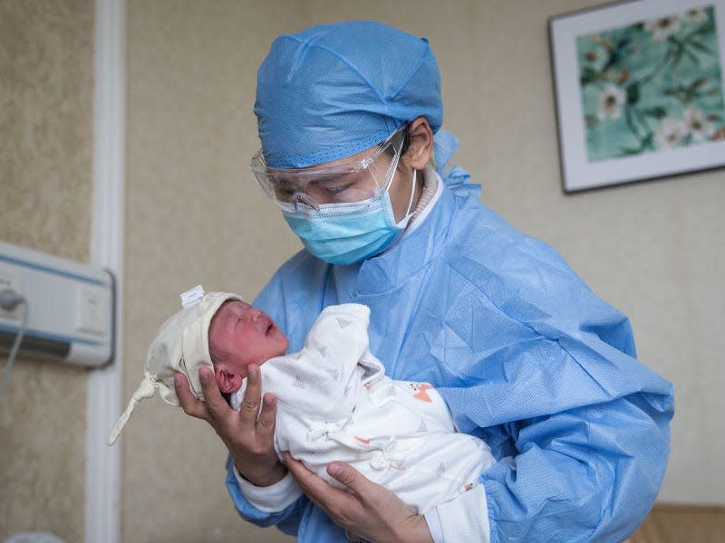 WUHAN, CHINA - FEBRUARY 21: A nurse holding a baby in a private obstetric hospital on February 21, 2020 in Wuhan, Hubei, China. Due to the shortage of medical resources in Wuhan, many pregnant women choose to give birth in private hospitals. World Health Organization (WHO) Director-General Tedros Adhanom Ghebreyesus said on January 30 that the novel coronavirus outbreak has become a Public Health Emergency of International Concern (PHEIC). (Photo by