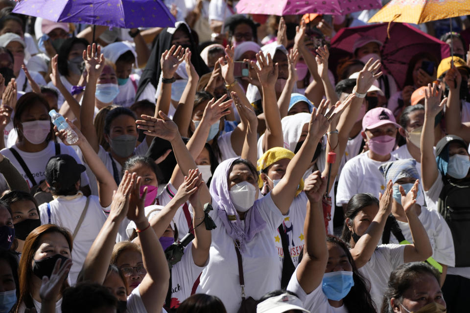 Supporters of Quezon City Mayor Joy Belmonte cheer as she starts her re-election campaign in Quezon City, Philippines on Friday, March 25, 2022. Candidates for thousands of provincial, town and congressional posts started campaigning across the Philippines Friday under tight police watch due to a history of violent rivalries and to enforce a lingering pandemic ban on handshakes, hugging and tightly packed crowds that are a hallmark of often circus-like campaigns. (AP Photo/Aaron Favila)