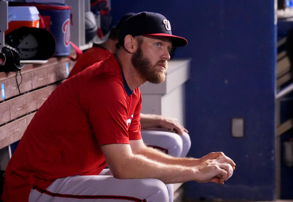 MIAMI, FLORIDA - JUNE 27: Stephen Strasburg #37 of the Washington Nationals tosses a ball in the dugout during the game against the Miami Marlins at loanDepot park on June 27, 2021 in Miami, Florida. (Photo by Mark Brown/Getty Images)