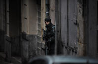 FILE - In this March 1, 2011 file photo, a Spanish Civil Guard stands next to the building where they arrested four alleged member of the Basque separatist armed group ETA, in Galdakao, northern Spain. Josu Urrutikoetxea, the last known chief of ETA, the now-extinct Basque separatist militant group, goes on trial Monday Oct. 19, 2020 in Paris for terrorism charges that he deems “absurd” because of his role in ending a conflict that claimed hundreds of lives and terrorized Spain for half a century. (AP Photo/Alvaro Barrientos, File)