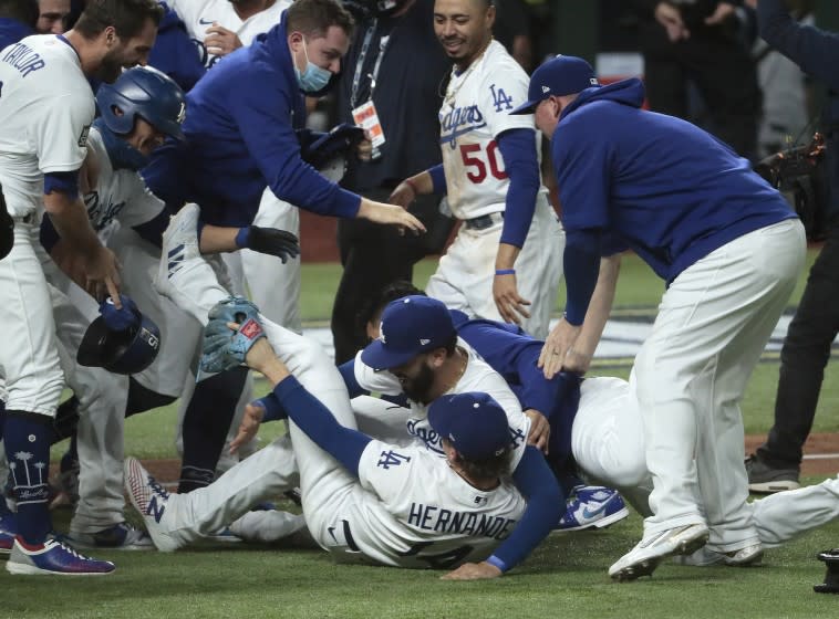 Arlington, Texas, Tuesday, October 27, 2020 Los Angeles Dodgers celebrate after beating the Rays in game six to win the World Series at Globe Life Field. (Robert Gauthier/ Los Angeles Times)
