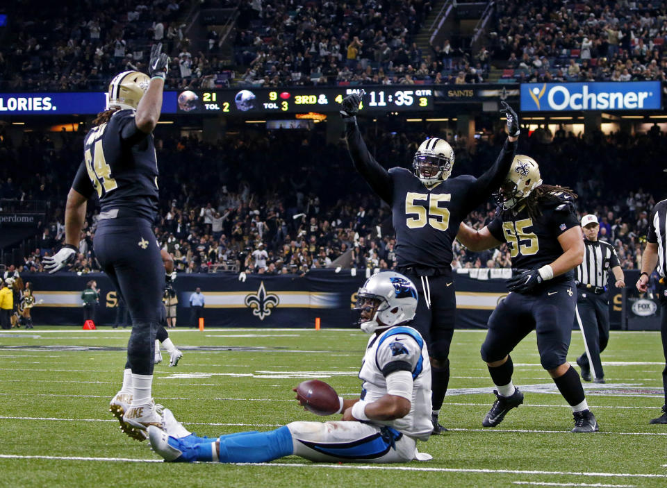 Saints linebacker Jonathan Freeny (55) celebrates his sack of Carolina's Cam Newton. New Orleans got to him four times in Sunday's tight NFC wild-card game. (AP) 