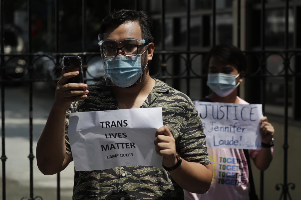 Protesters holds a slogan during a rally outside the Department of Justice in Manila, Philippines, Thursday Sept. 3, 2020. A Philippine court has ordered the early release for good conduct of U.S. Marine Lance Cpl. Joseph Scott Pemberton convicted in the 2014 killing of transgender Filipino Jennifer Laude which sparked anger in the former American colony. (AP Photo/Aaron Favila)