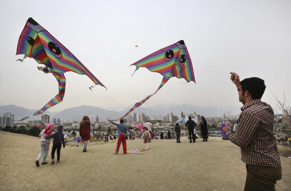 Iranians fly kites during the ancient festival of Sizdeh Bedar, an annual public picnic day on the 13th day of the Iranian new year, at Pardisan Park, in Tehran, Iran, Wednesday, April 2, 2014. Sizdeh Bedar, which comes from the Farsi words for “thirteen” and “day out,” is a legacy from Iran’s pre-Islamic past that hard-liners in the Islamic Republic never managed to erase from calendars. State media and calendar makers choose to call the festival “Nature Day” instead of Sizdeh Bedar, given the bad-luck associations with the number 13. (AP Photo/Vahid Salemi)