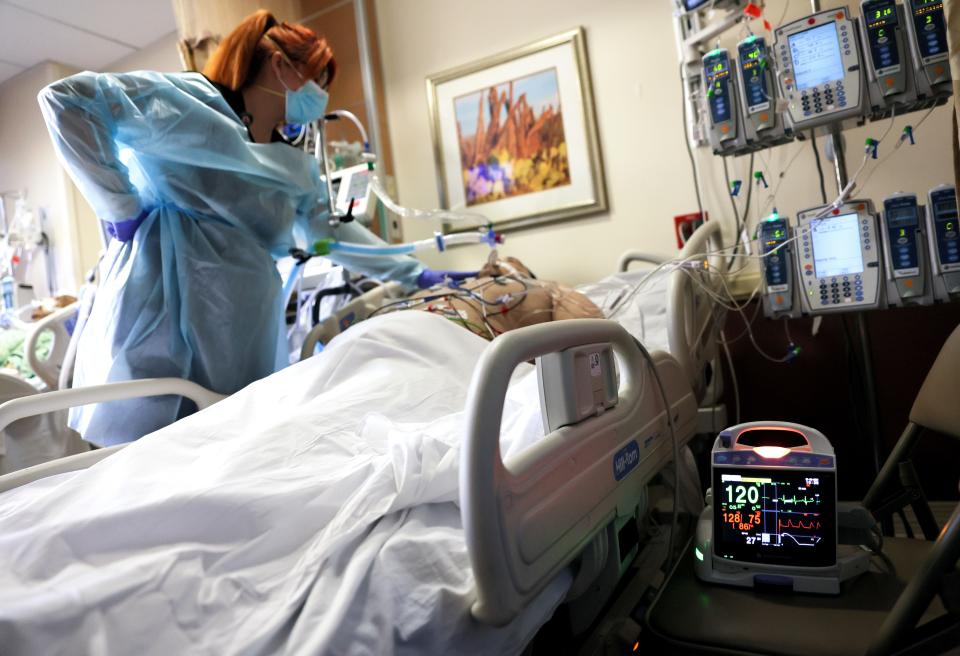 The capacity of the destination’s health care system should also be considered in travel plans now that certain hospitals are running out of available ICU beds. In this Jan. 6, 2021 photo, a clinician cares for a COVID-19 patient amid a surge in COVID-19 patients across Southern California.