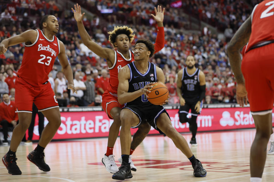 Duke's Wendell Moore, front, tries to shoot over Ohio State's Meechie Johnson during the first half of an NCAA college basketball game Tuesday, Nov. 30, 2021, in Columbus, Ohio. (AP Photo/Jay LaPrete)