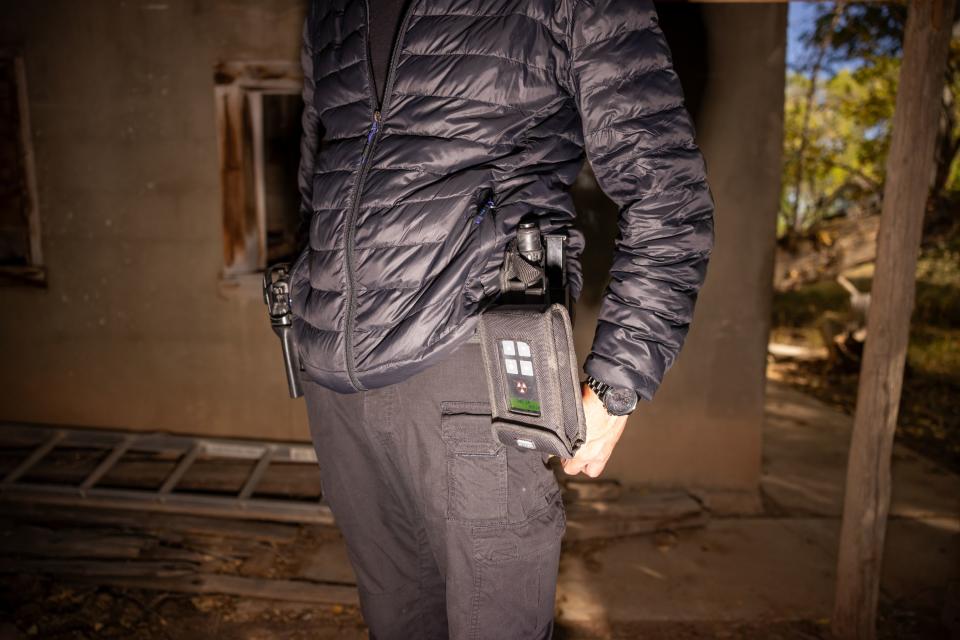 Bryant “Dragon” Arnold, head of security at Skinwalker Ranch, carries a handgun and a geiger counter, which measures radiation levels, while taking journalists on a tour of the property in rural Uintah County on Thursday, Oct. 5, 2023. | Spenser Heaps, Deseret News