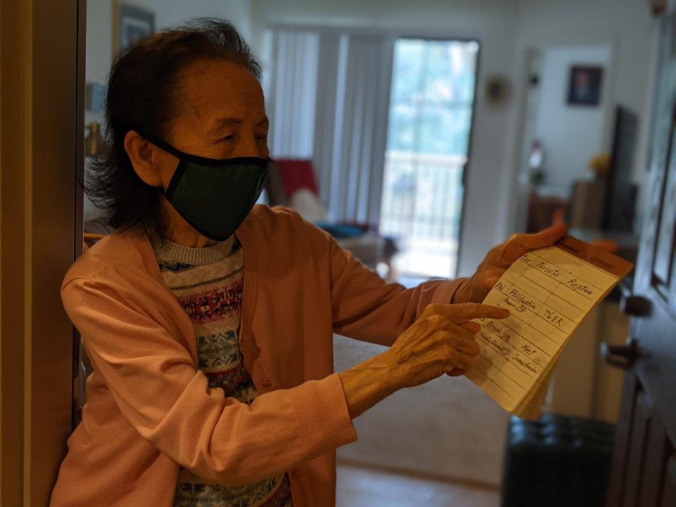 Lili Gu's grandmother points to her list of favorite NBA players.