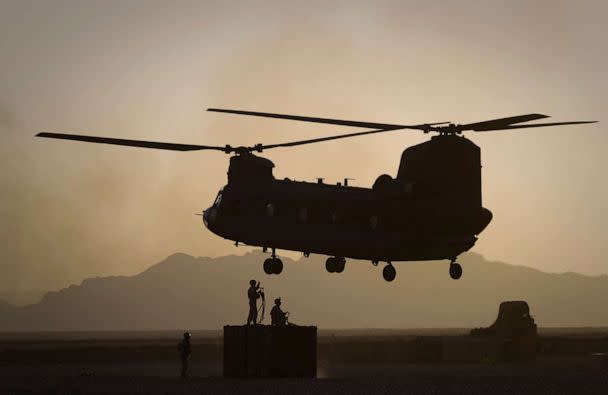 FILE PHOTO: In this file photo taken on June 9, 2011, U.S. Marines direct a Chinook helicopter arriving to pick up a container with supplies at Forward Operating Base E Edinburgh in the Helmand Province of southern Afghanistan. (Anja Niedringhaus/AP, File.)