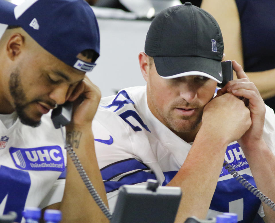 FILE - In this Aug. 31, 2017, file photo, Dallas Cowboys' Dak Prescott, left, and Jason Witten, right, take calls during The Salvation Army telethon at AT&T Stadium in Arlington, Texas. The NFL is planning a telethon to aid coronavirus relief efforts during the draft from April 23-25, 2020, according to two people familiar with the league’s plans. The people tell The Associated Press that the league hopes its massive reach will raise awareness and funds in battling the pandemic. They spoke to the AP on condition of anonymity because the telethon has not been announced publicly. (Ron Baselice/The Dallas Morning News via AP, File)