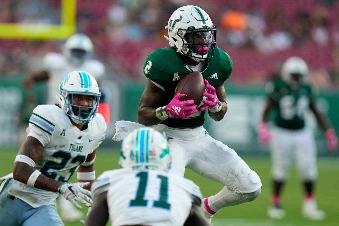 South Florida running back Michel Dukes (2) makes a catch in front of Tulane safety Lummie Young IV (23) and defensive back Jarius Monroe during the second half of an NCAA college football game Saturday, Oct. 15, 2022, in Tampa, Fla. (AP Photo/Chris O’Meara)