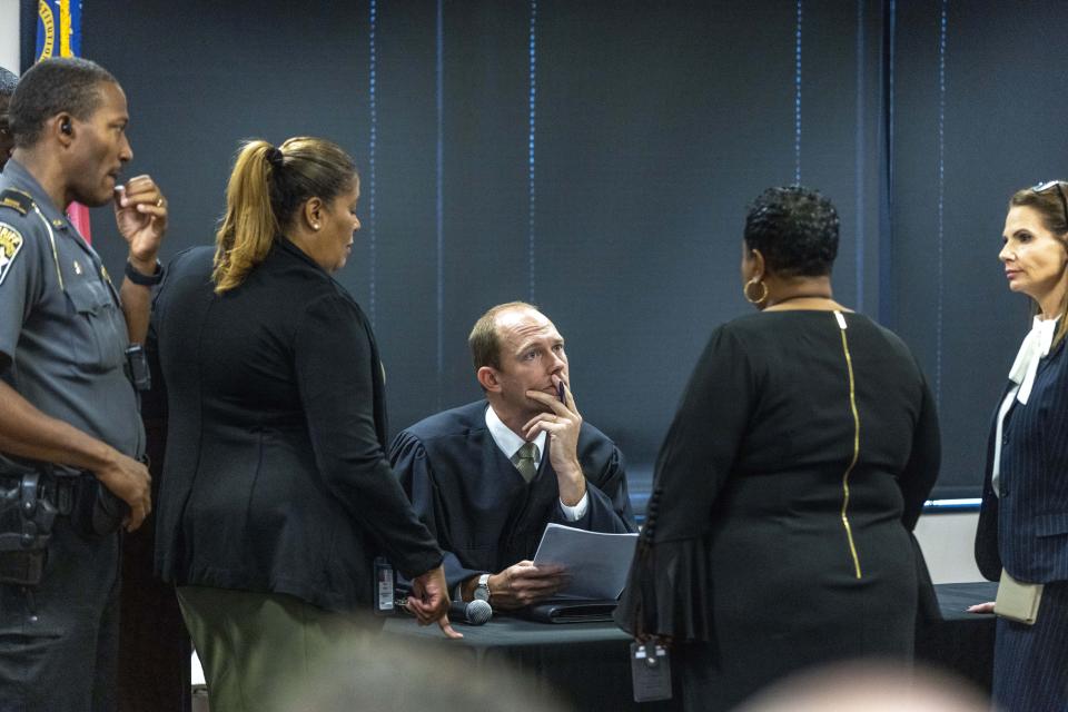 Fulton Superior Court Judge Scott McAfee, center, receives information during jury selection for lawyer Kenneth Chesebro's trial, Friday, Oct. 20, 2023, at the Fulton County Courthouse in Atlanta. Jury selection began Friday for Chesebro, the first defendant to go to trial in the Georgia case that accuses former President Donald Trump and others of illegally scheming to overturn the 2020 election in the state. (Alyssa Pointer/Pool Photo via AP)
