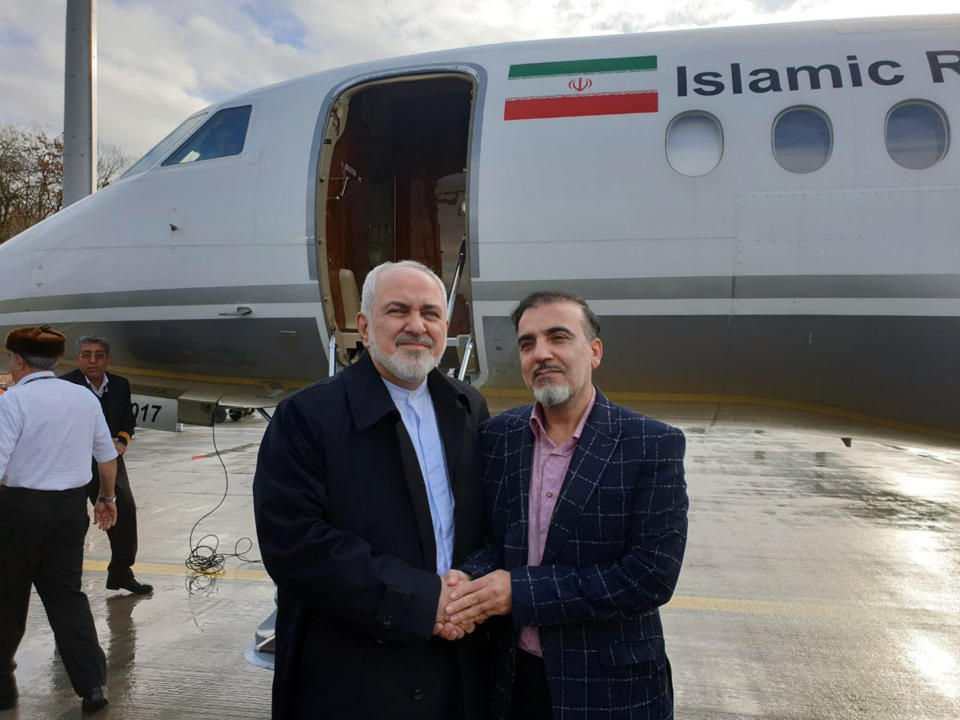 In this photo released on twitter account of Iran's Foreign Minister Mohammad Javad Zarif , Zarif, left, shakes hand with Iranian scientist Massoud Soleimani prior to leaving Zurich, Switzerland for Tehran, Iran, Saturday, Dec. 7, 2019. Iran and the U.S. conducted a prisoner exchange Saturday that saw a detained Princeton scholar released for an Iranian scientist held by America, marking a rare diplomatic breakthrough between Tehran and Washington after months of tensions. (Javad Zarif twitter account via AP)