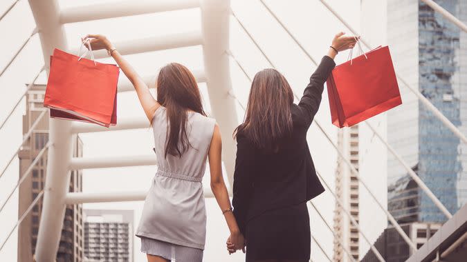 Shopaholic lifestyle friendship women holding shopping bag in shopping mall center.