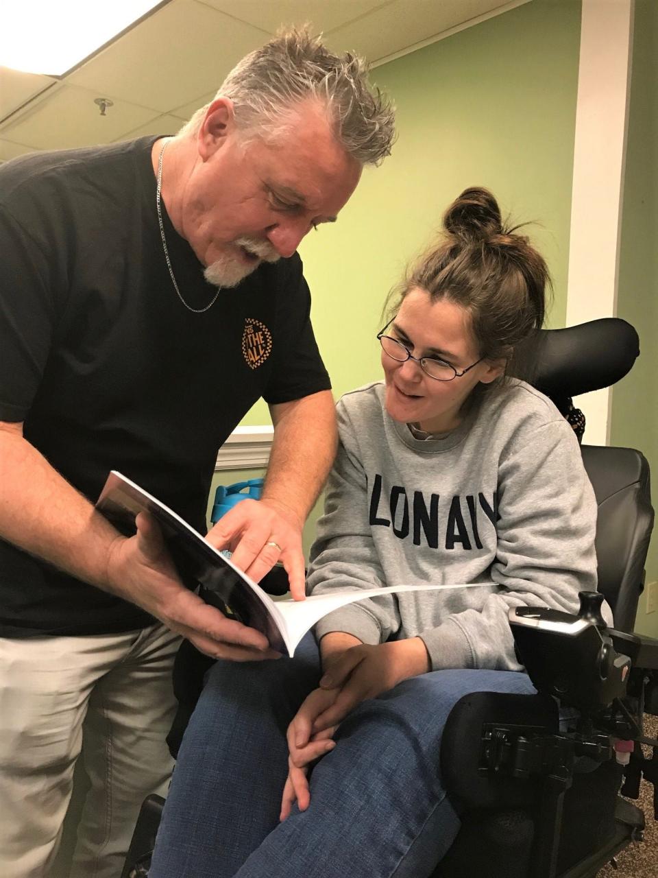 X Church Care and Outreach Pastor Steve Rauch and artist Jess Campbell look over the children's book Rauch wrote and Campbell illustrated. The book is called "The Three Little People Pigs."