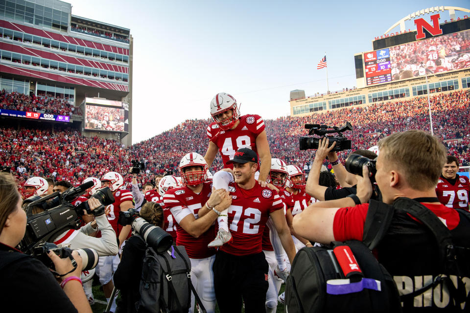 FILE - In this Saturday, Oct. 5, 2019, file photo, Nebraska kicker Lane McCallum (48) is carried off the field by his teammates after kicking the game-winning field goal as time expired in an NCAA college football game against Northwestern, in Lincoln, Neb. Nebraska's 24-sport program has about 600 athletes and is one of a handful that makes money. Though a 10% budget cut was announced recently, the program is able to absorb the cost of coronavirus testing, in part because of its affiliation with the university’s medical school. (Francis Gardler/Lincoln Journal Star via AP, File)