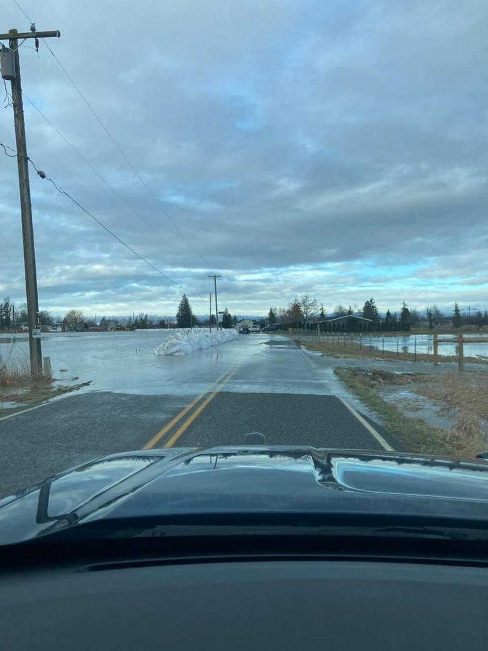Police closed Emerson Road south of downtown Everson because of water over the pavement on Sunday as the Nooksack River rose sharply amid heavy rain across Whatcom County and causing rapid snowmelt in the mountains.