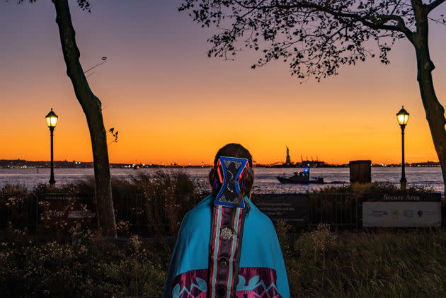 River Whittle gazes out toward the Statue of Liberty, which welcomes millions from around the globe into Lenapehoking. Not far is a historical meeting place where Lenape residents would welcome visitors from other Indigenous nations for thousands of years. Today, it can be immensely challenging for Lenape people to feel welcome and connected to their own homelands. (Photo: Joe Whittle for HuffPost)