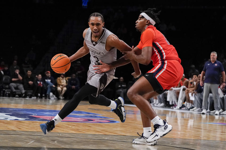 St. Bonaventure guard Mika Adams-Woods (3) moves the ball against Auburn guard Denver Jones (12) during the second half of an NCAA college basketball game in the final of the Legends Classic tournament in New York, Friday, Nov. 17, 2023. (AP Photo/Peter K. Afriyie)