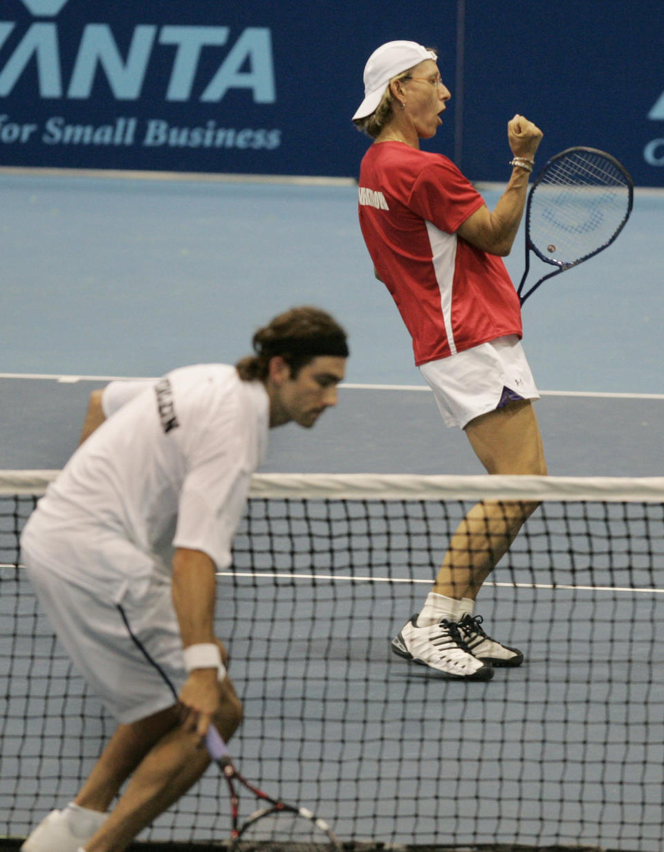 FILE - In this July 7, 2005 file photo, Boston Lobsters' Martina Navratilova celebrates after sending the ball past opponent Mark Merklein of the New York Sportimes during mixed doubles World Team Tennis action in Boston. After a February 2019 public exchange involving Navratilova, who came out as a lesbian in 1981 and is a longtime gay-rights activist, she now stands accused of being "transphobic" after asserting that many transgender women _ even if they've taken required hormone treatment _ have an unfair advantage over other female competitors. (AP Photo/Elise Amendola)