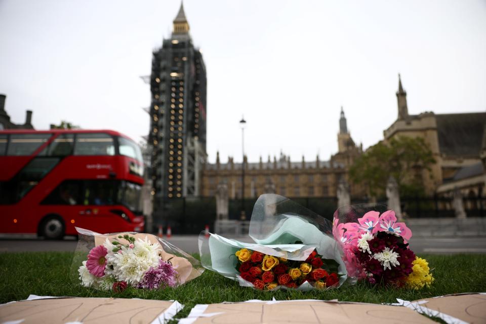 Image: Floral tributes to killed British MP Amess outside parliament in London (Henry Nicholls / Reuters)