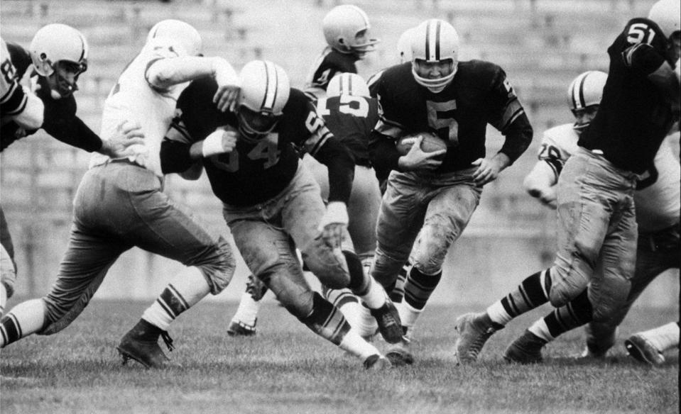 FILE - In this Aug. 10, 1959 file photo, Paul Hornung (5) of the Green Bay Packers goes through the line in an inter-squad game in Green Bay, Wis. Hornung, the dazzling “Golden Boy” of the Green Bay Packers whose singular ability to generate points as a runner, receiver, quarterback, and kicker helped turn them into an NFL dynasty, has died, Friday, Nov. 13, 2020. He was 84. (AP Photo, File)
