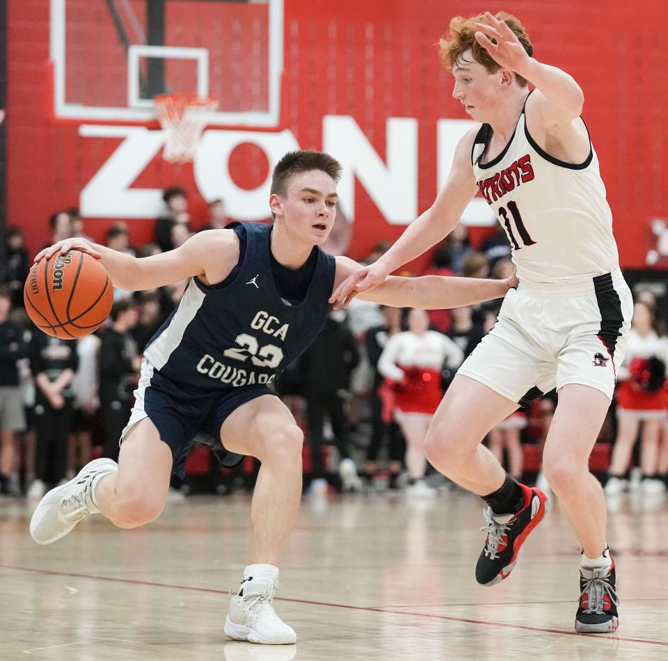 Greenwood Christian Academy Cougars Max Booher (23) rushes up the court against Bethesda Christian Patriots Luke Stuckey (11) on Thursday, Feb. 9, 2023 at Bethesda Christian High School in Brownsburg. The Greenwood Christian Academy Cougars defeated the Bethesda Christian Patriots, 66-43. 