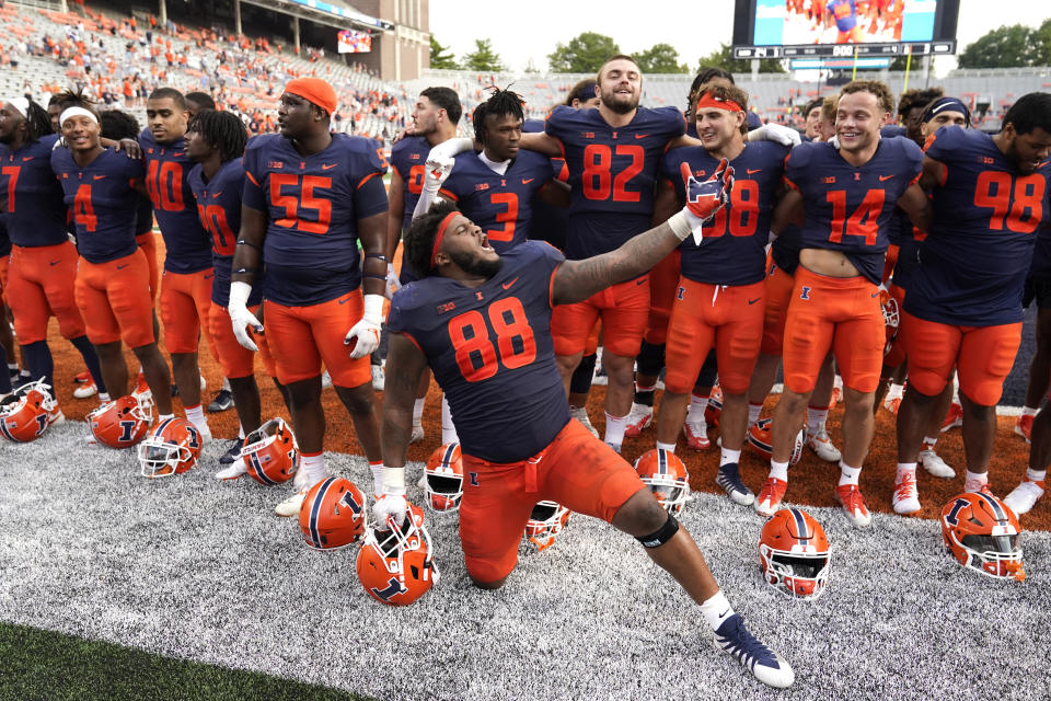 Illinois defensive lineman Keith Randolph Jr., leads his teammates in singing the school's alma mater after an NCAA college football game against Virginia, Saturday, Sept. 10, 2022, in Champaign, Ill. Illinois won 24-3. (AP Photo/Charles Rex Arbogast)