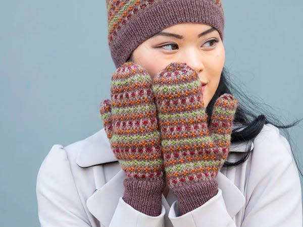 model wearing hat and gloves made with the Autumn Blossom Hat & Mittens Kit 