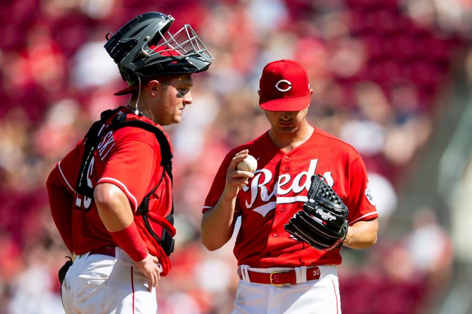 Cincinnati Reds catcher Michael Papierski (26) speaks with Cincinnati Reds starting pitcher Tyler Mahle (30) after a walk in the second inning of the MLB game between the Cincinnati Reds and the Atlanta Braves at Great American Ball Park in Cincinnati on Saturday, July 2, 2022.