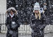 <p>Women walk on a street as snow falls during winter storm Quinn on March 7, 2018 in Hoboken, N.J. This is the second nor’easter to hit the area in a week, and is expected to bring heavy snowfall and winds, raising fears of another round of electrical outages. (Photo: Kena Betancur/Getty Images) </p>