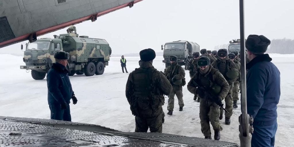 Russian servicemen boarding a military aircraft on their way to Kazakhstan