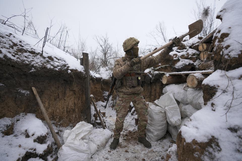 An Ukrainian serviceman cleans his position in a trench on the front line in the Luhansk region, eastern Ukraine, Friday, Jan. 28, 2022. High-stakes diplomacy continued on Friday in a bid to avert a war in Eastern Europe. The urgent efforts come as 100,000 Russian troops are massed near Ukraine's border and the Biden administration worries that Russian President Vladimir Putin will mount some sort of invasion within weeks. (AP Photo/Vadim Ghirda)