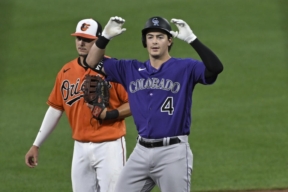 Colorado Rockies' Michael Toglia (4) gestures after hitting a double against the Baltimore Orioles during the third inning of a baseball game Saturday, Aug. 26, 2023, in Baltimore. (AP Photo/Terrance Williams)