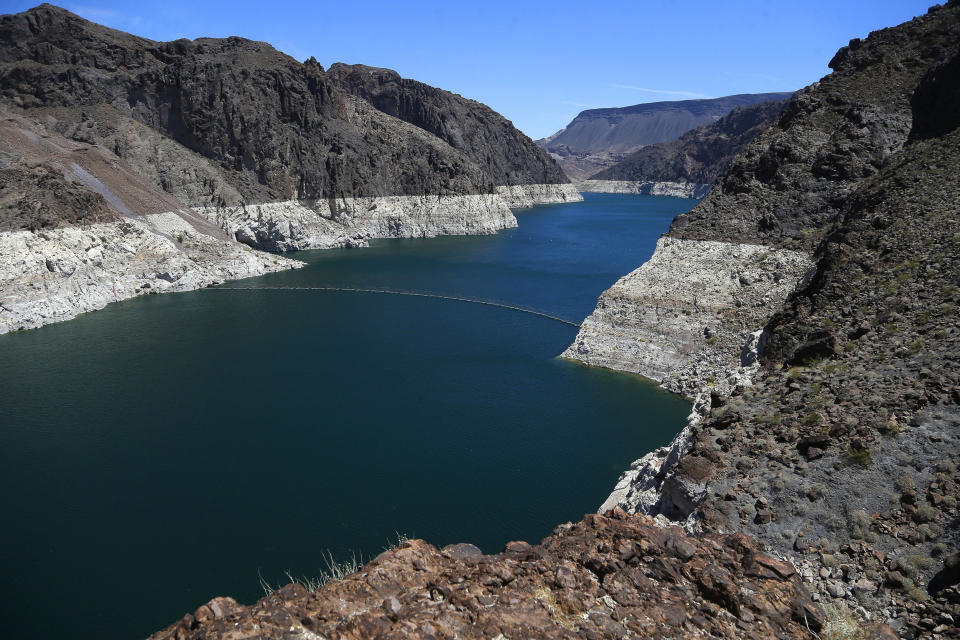 FILE - This May 31, 2018 file photo shows the reduced water level of Lake Mead behind Hoover Dam in Arizona. Arizona is nearing a deadline to approve a plan to ensure a key reservoir in the West doesn't become unusable as a water source for farmers, cities, tribes and developers. Other Western states are watching. The U.S. Bureau of Reclamation expects full agreement on a drought contingency plan by Thursday, Jan. 31, 2019. (AP Photo/Ross D. Franklin, File)