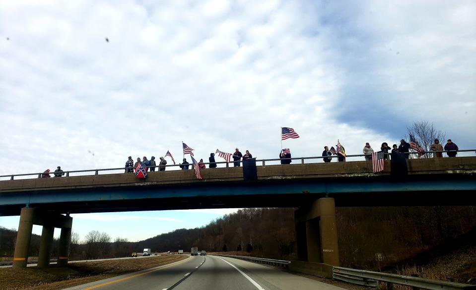 Supporters of The People's Convoy line the overpass on I-70 waiting for the convoy to pass through.