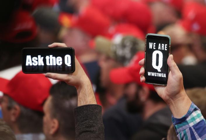 Supporters of President Donald Trump hold up their phones with messages referring to the QAnon conspiracy theory at a campaign rally at Las Vegas Convention Center on February 21, 2020 in Las Vegas, Nevada.