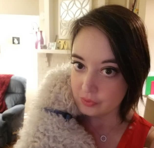 The author hugs one of her dogs in her apartment.