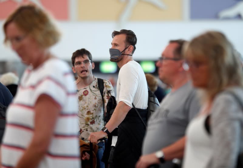 Tourists at Gran Canaria airport wait to return to their countries after closure of hotels