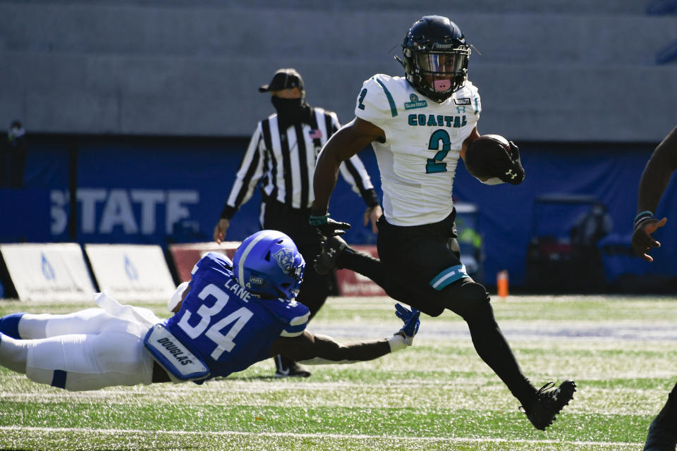 Coastal Carolina running back Reese White (2) evades a tackle by Georgia State safety Antavious Lane (34) as he runs for a touchdown during the first half of an NCAA football game Saturday, Oct. 31, 2020, in Atlanta. (AP Photo/John Amis)