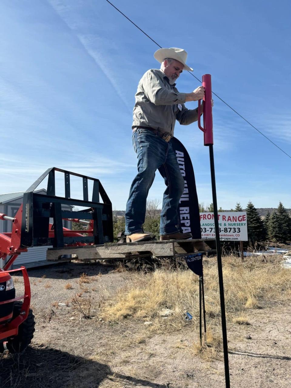 State Representative Richard Holtorf stands on a pallet raised by a steer loader in a picture posted by his campaign in February (Facebook: Richard Holtorf)