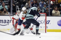 Florida Panthers defenseman Marc Staal (18) collides with Seattle Kraken defenseman Carson Soucy (28) in front of the goal during the first period of an NHL hockey game Saturday, Dec. 3, 2022, in Seattle. (AP Photo/John Froschauer)