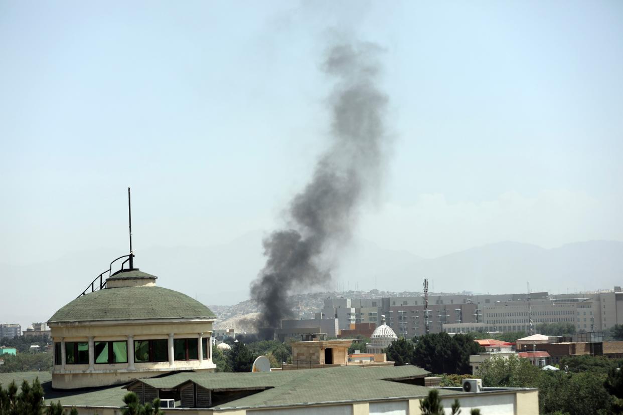 Smoke rises next to the U.S. Embassy in Kabul, Afghanistan on Sunday, Aug. 15, 2021. Taliban fighters entered the outskirts of the Afghan capital on Sunday, further tightening their grip on the country as panicked workers fled government offices and helicopters landed at the embassy. Wisps of smoke could be seen near the embassy's roof as diplomats urgently destroyed sensitive documents, according to two American military officials.